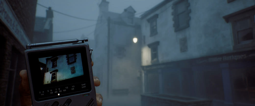 Simon Ordell holding the CRTV pocket television in a fog-bound St. Amelia street — official SILENT HILL: Townfall artwork